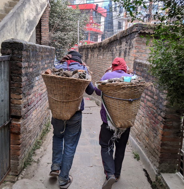 Kathmandu construction material being moved in doko baskets